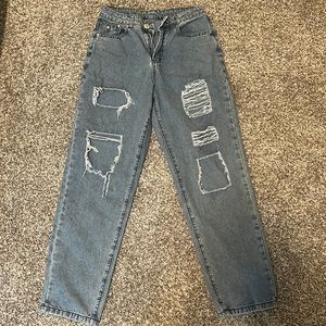 Size small, baggy, blue jeans that hang low on the waist.